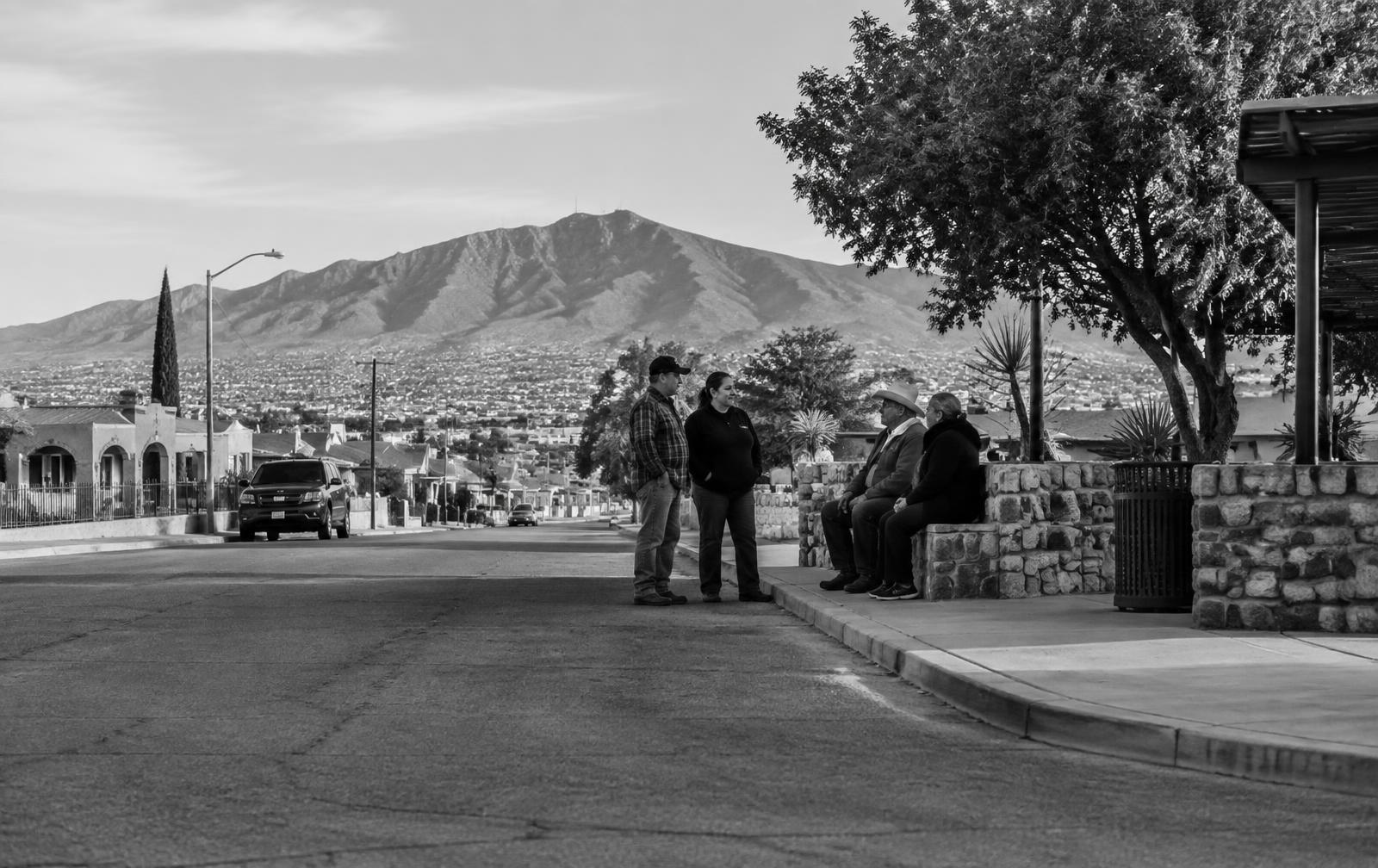 El Paso neighbors speaking on a quiet street near the Franklin Mountains